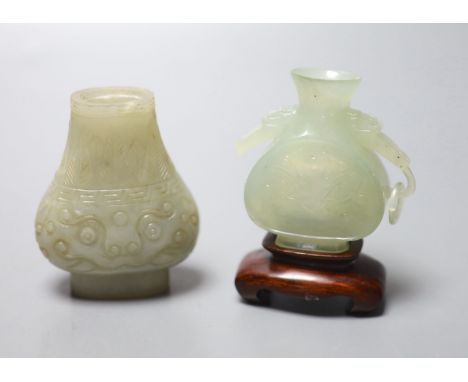 A Chinese celadon green jade vase, 7.4cm (lacking handles) and a Chinese bowenite jade vase, wood stand