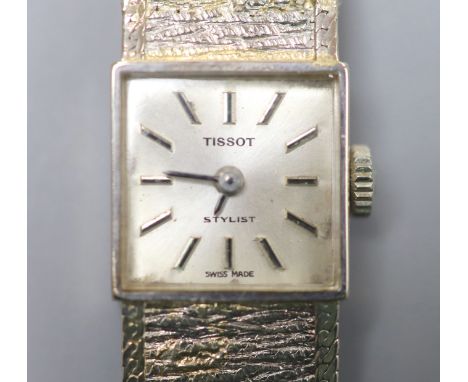 A lady's textured 9ct white gold Tissot manual wind bracelet wrist watch, overall length 17cm, gross 22 grams.
