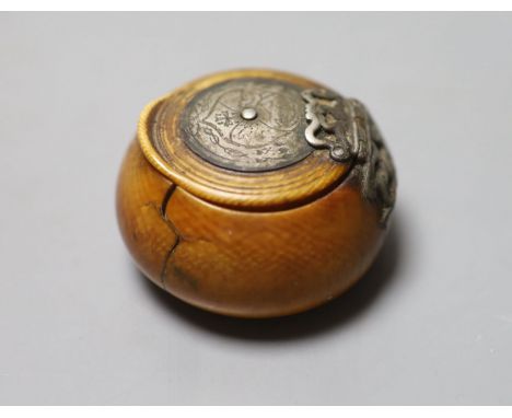 A 17th century French white metal mounted ivory snuff box, with pique work to inner lid, diameter 4.5cm the pique work simila