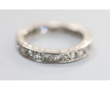 A white metal and diamond set full eternity ring, size K/L, gross 3.5 grams.CONDITION: Two of the diamonds each have a small 