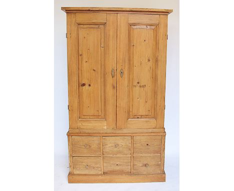 A pine kitchen cabinet / spice cupboard, with two doors enclosing an arrangement of twenty six drawers, with two secret drawe