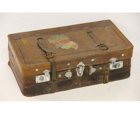 A vintage leather suitcase with applied labels for the 'Commodore Hotel, Tehran-Iran', 63cm wide 