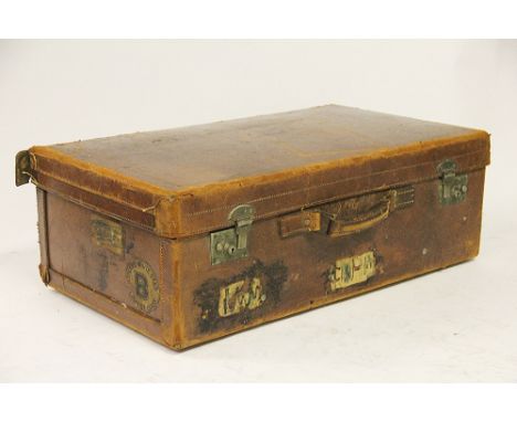 A vintage tan leather suitcase, with Cunard White Star Line luggage label dated 1958 and other Chateau Frontenac Canadian Pac