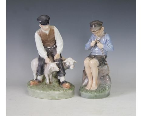 A Royal Copenhagen figure of a boy and two goats, numbered 627, 20cm high and a figure of a boy whittling a stick number 905,