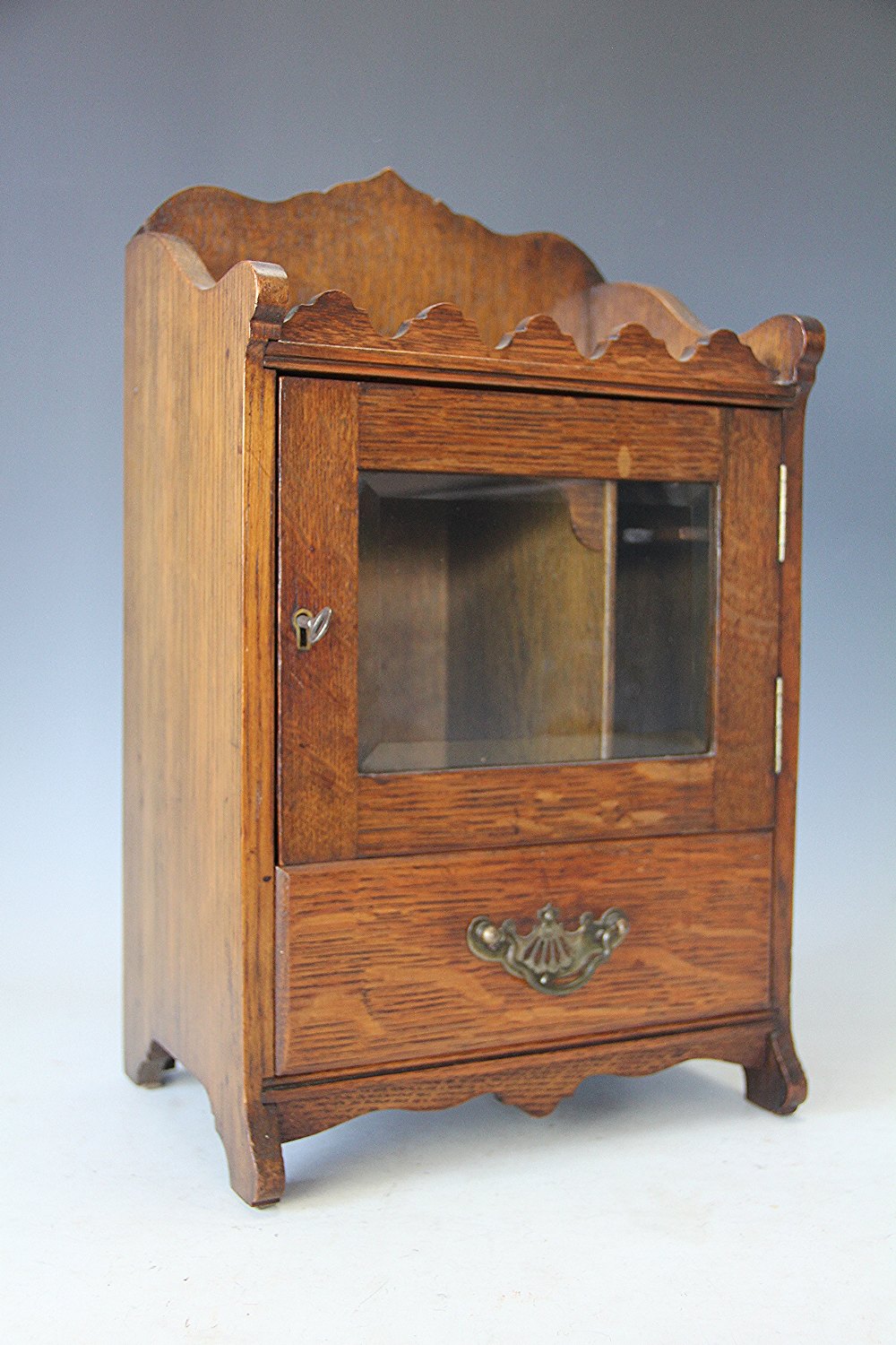 A late Victorian oak smokers with door and drawer, 41cm tall