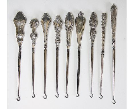 A collection of nine silver handled button hooks, Victorian and later, to include; Cooper Bros & Sons, Sheffield 1909, fleur 