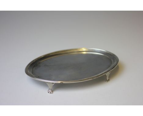 A George III silver teapot stand, William Vincent, London 1786, of plain oval form and raised on four reeded bracket feet, 18