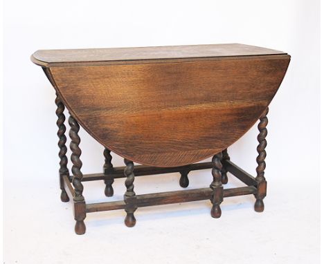 A light oak gate leg table, on barley twist legs