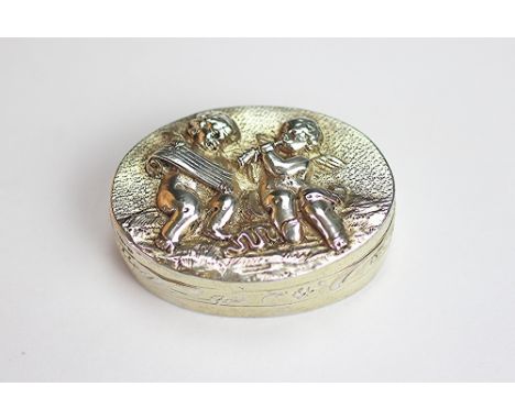 A silver oval box, import mark for Berthold Muller, Chester 1909, the cover embossed with cherubs playing musical instruments