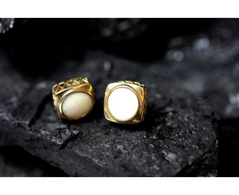 A pair of opal set stud earrings, each circular opal set within square yellow metal surround with carved gallery, stamped '37