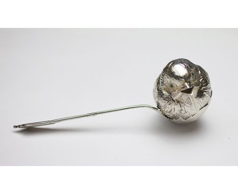 A novelty silver baby's feeding spoon, Sampson Mordan, Chester 1906, designed as a chick hatching from an egg with green ston