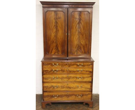 A late George III mahogany secretaire cabinet, with dentil cornice above two panelled doors, enclosing adjustable shelves, ab