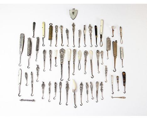 A quantity of silver handled and other glove hooks, 19th century and later, to include folding, retractable, multiple use too