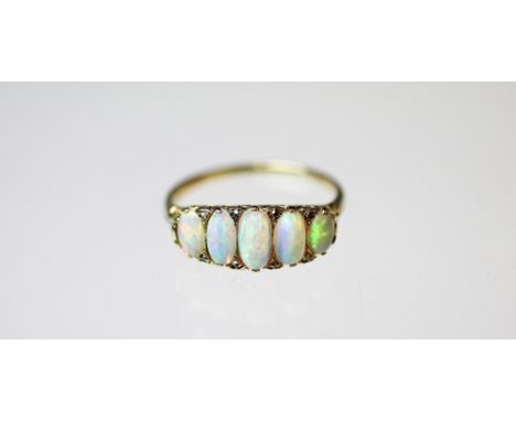 An opal five stone ring, the five graduated opals each interspersed with rose cut diamond points, all set in yellow gold to t