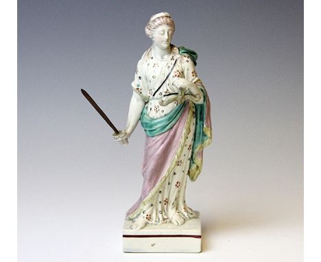 An 18th century Pratt figure of a Classical lady holding a balance and a sword, wearing classical drapes and raised on brown 