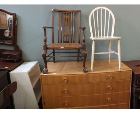 A modern light oak chest of five drawers, a mahogany cane seat elbow chair, a white painted bookcase and kitchen chair