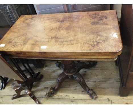 A Victorian mahogany folding top card table on carved column and quatrefoil base
