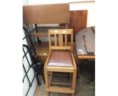 A dark Ercol drop leaf coffee table, a trolley and a high chair