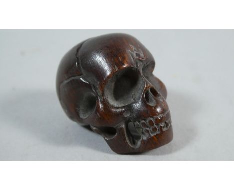 A Carved Netsuke in the Form of a Skulls, 2.5cm High