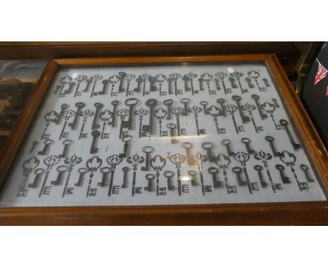 A Wall Mounting Display of Vintage Keys, 71cm Wide 