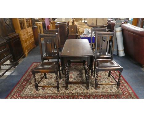 An Oak Gate Leg Barley Twist Drop Leaf Dining Table with Oval Top Together with Four Oak Framed Dining Chairs 