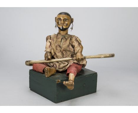 A rare late 19th century Indian musician automaton, carved and painted wood, pierced ears with large hoop and bead earrings, 