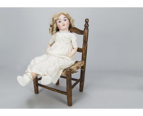 A Max Handwerck 283 child doll,  with blue sleeping eyes, replaced blonde mohair wig, jointed composition body, cream dress a