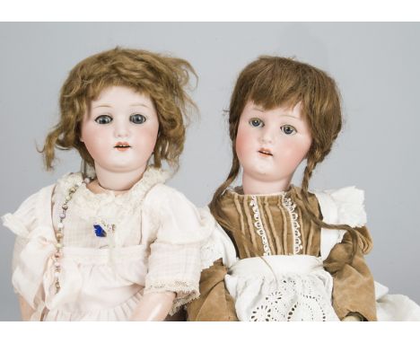 Two Ernst Heubach 250 child dolls, with blue sleeping eyes, jointed composition bodies, one with brown mohair wig in pink dre