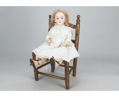 A Max Handwerck 283 child doll,  with blue sleeping eyes, replaced blonde wig, jointed composition body, white cotton dress, 