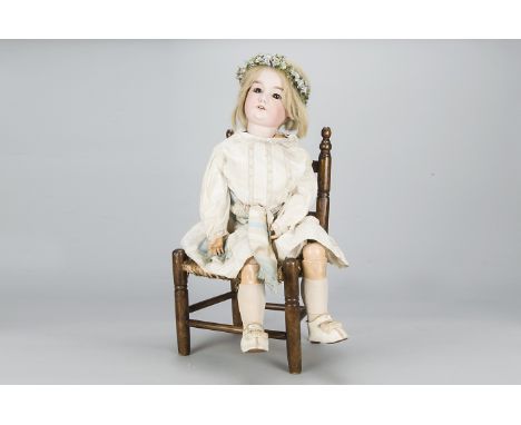 A large Armand Marseille child doll,  with brown sleeping eyes, blonde hair wig, jointed composition body, white cotton dress