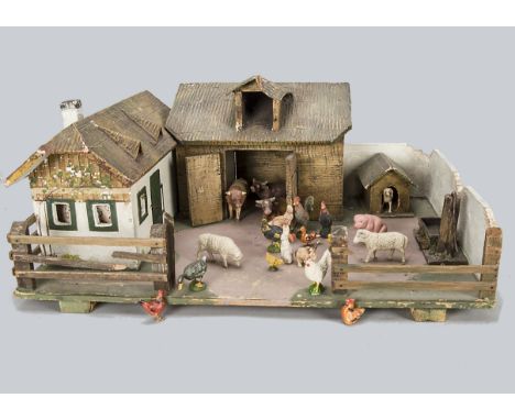 A Tipple-Topple farm yard,  with painted wooden farm house, barn and kennel with composition textured roofs, walled yard, pum