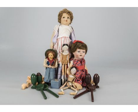 Various dolls,  a pegged wooden doll —10in. (25.5cm.) high, another turned into a puppet, an English bisque Cecily character 