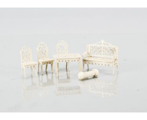 Small scale bone dolls’ house furniture,  a sofa with intricate pierced back and seat —2in. (5cm.) wide, three similar chairs