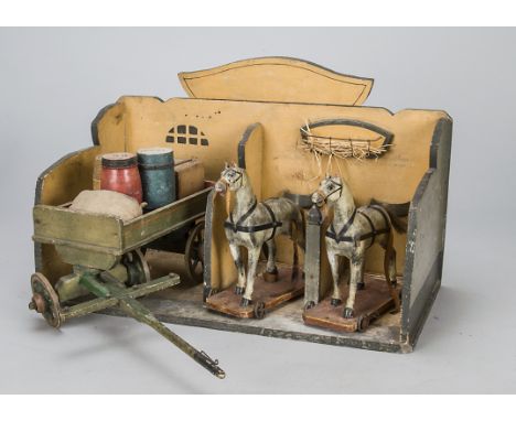 A good quality wooden stable,  with two carved and painted wooden dapple grey horses with open mouths, horsehair tails on red
