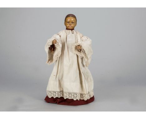 An interesting Swiss carved wooden choir boy,  probably originally a hand puppet, now with wired leather body, the shoulder h