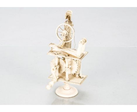 A 19th century Napoleonic Prisoner of War Spinning Jenny automaton,  the carved bone lady with large bonnet sat at her spinni