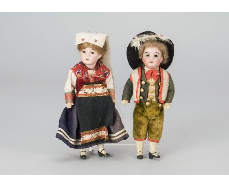 A Gerbruder Kuhnlenz boy and girl doll,  with fixed dark eyes, the girl with light brown wig, the boy with curly blonde, stra