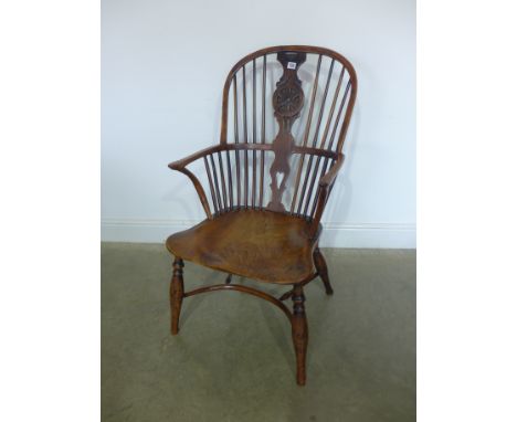 A 19th century elm and yew stick back Windsor chair with a crinoline stretcher - with restorations