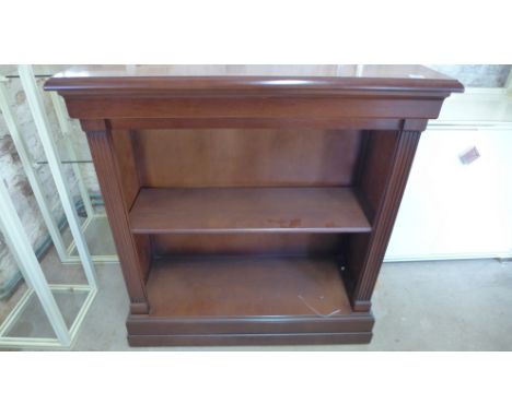 A modern mahogany bookcase with an adjustable shelf