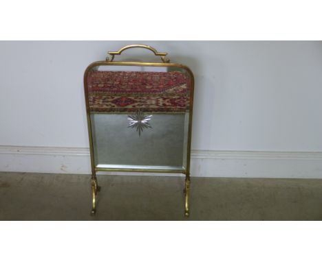 A brass fire screen with cut glass mirror centre