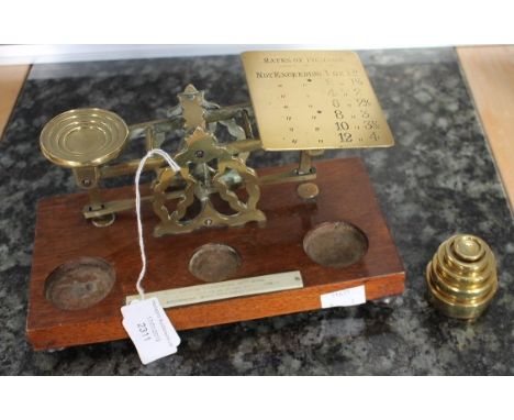 Set of early 20th Century brass postage scales with weights open mahogany base, 22 cms wide