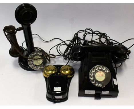 A mid 20th Century spin dial black Bakelite telephone, with address tray, together with a 1930's black painted metal candlest