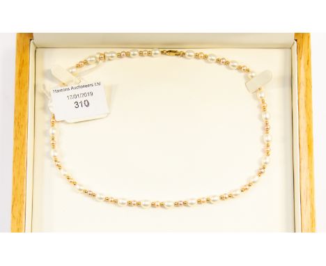 A cultured pearl necklace with alternate white and peach pearls with 9ct gold bead spacers,  and clasp, 18'' in length, boxed