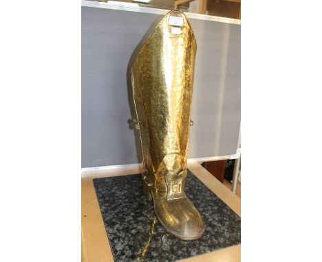 A brass stick stand, as a boot; a brass lamp (Bullpit and Sons) 1909; a jolly moneybank (3)
