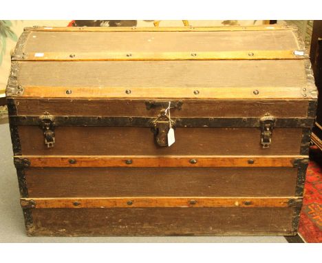 A dome loped trunk, metal corners, original lock, covered in brown Hessian 
