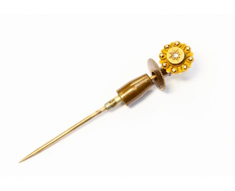 A Victorian 18ct gold stick pin, star set with a small diamond to the centre, length approx 55mm