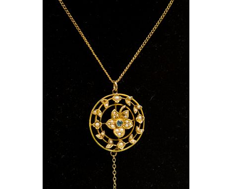 An Edwardian 15ct gold pendant, circular open design with seed pearl and blue stone flower centre, garland surround set with 