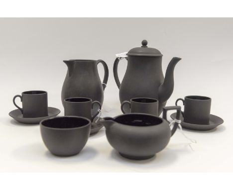 A Wedgwood black basalt coffee set, coffee pot, water jug, cream jug, sucrier, four cans and four saucers, the inside is blac