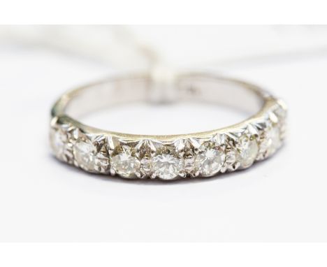 A diamond half set eternity ring, with eight brilliant-cut diamonds in white metal mount, total diamond weight approx 0.56ct,