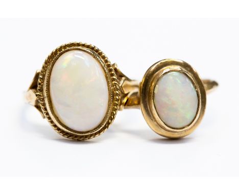 Two 9ct. yellow gold and opal rings, both set oval cabochon opal and hallmarked for 9 carat gold to shank, (total gross weigh